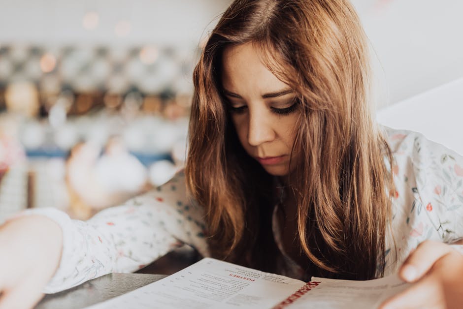Young woman intensely focused on reading a menu inside a café, creating an introspective and cozy atmosphere