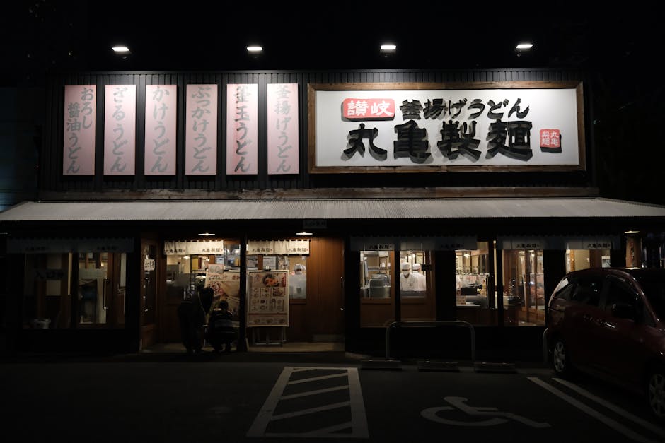 Exterior of a traditional udon restaurant in Toyohashi, Japan, illuminated at night