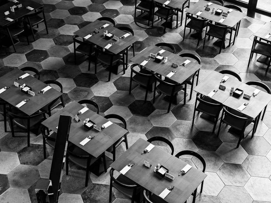 High angle view of empty tables and chairs in a modern restaurant with a hexagonal tile floor
