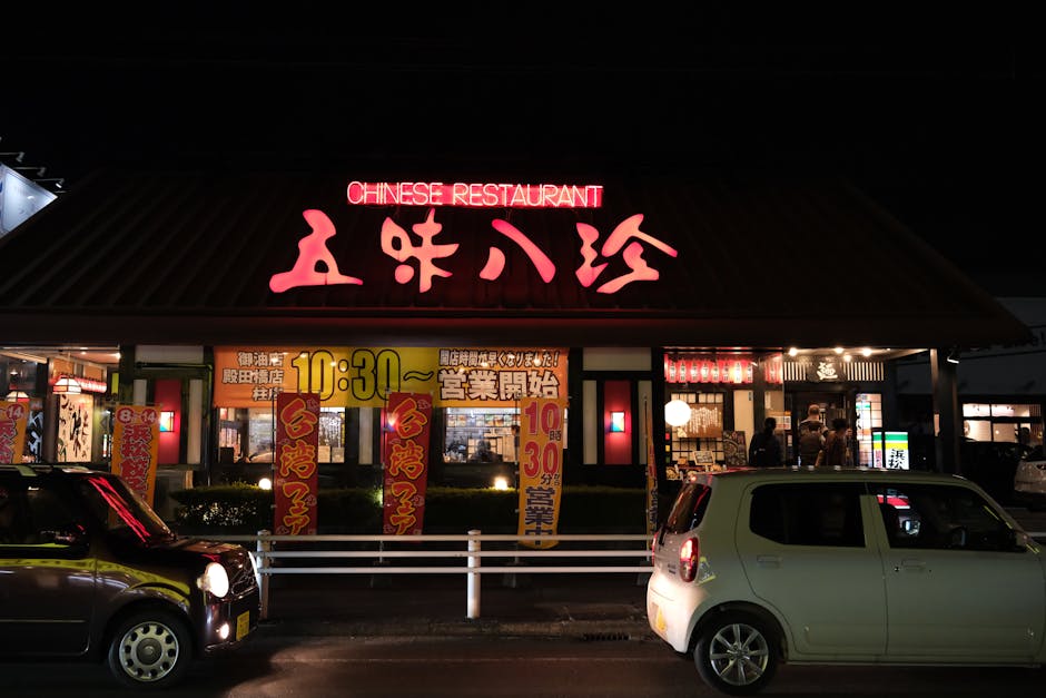 Illuminated Chinese restaurant in Toyohashi, Japan with cars at night