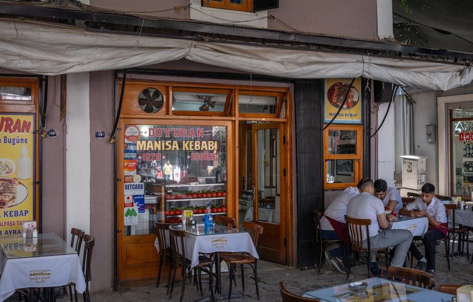 People enjoying outdoor dining at Doyuran Manisa Kebab in vibrant İzmir city street