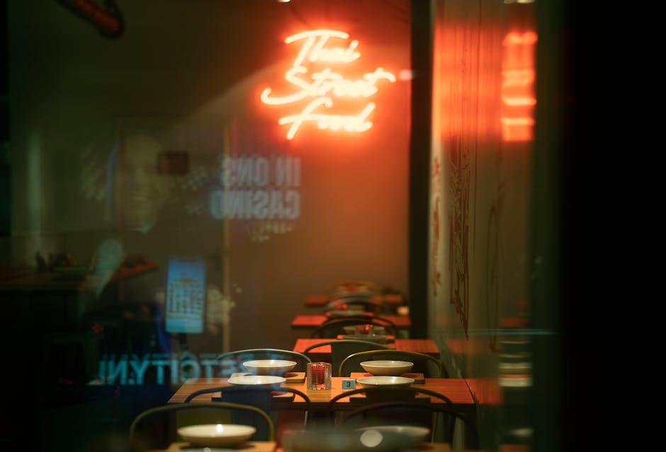 Inviting interior of a Thai street food cafe with neon signs and cozy table settings